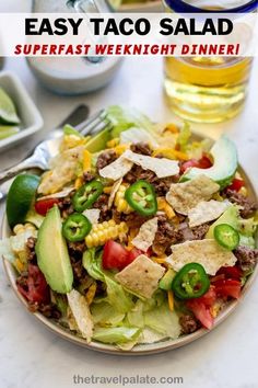 Easy Taco Salad Recipe is a quick and flavorful weeknight dinner that the whole family can enjoy! This version is made with iceberg lettuce, ground beef, tomatoes, corn, chipotle peppers, avocado and a creamy salsa-ranch dressing. This recipe won't disappoint when the Tex-Mex cravings hit, but you're in the mood for lighter fare. via @thetravelpalate