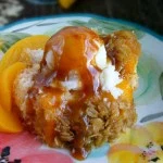 Best Buttermilk Peach Cobbler Cake Topped with Crumbled Oats Caramel Sauce and Ice Cream