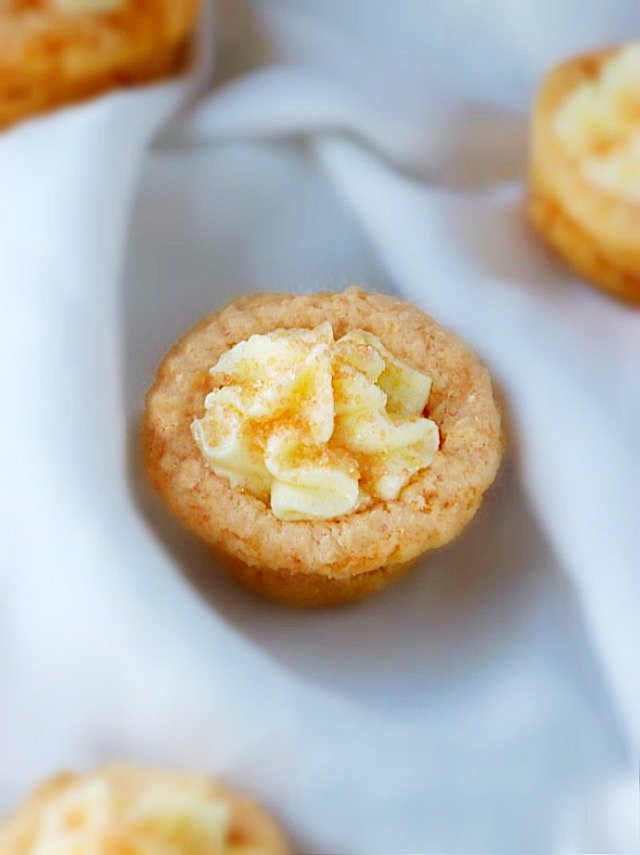 An Orange Creamsicle Cookie Cup with a light and fluffy orange topping