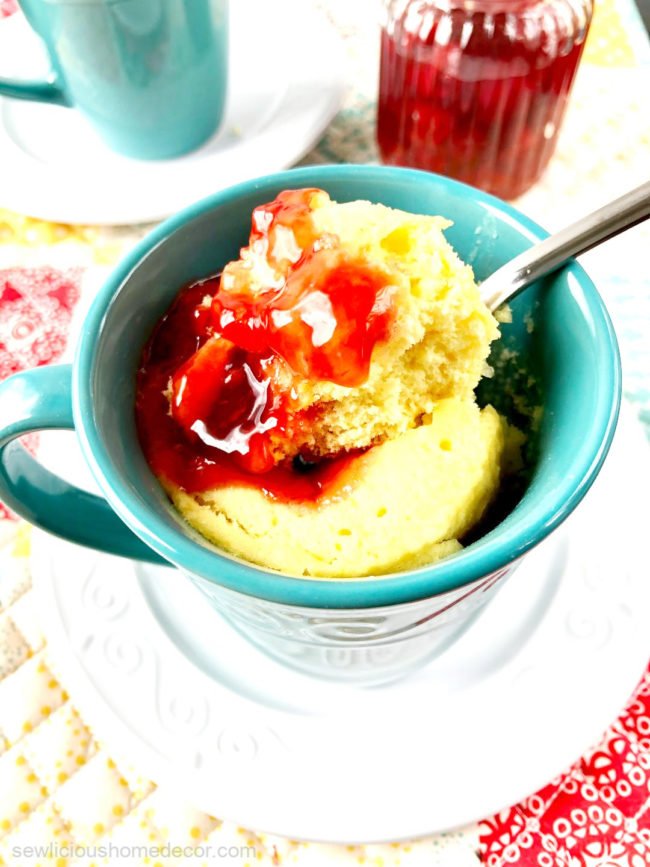 Individual microwaveable cherry cobbler mug cake made with a yellow cake mix and cherry pie filling.